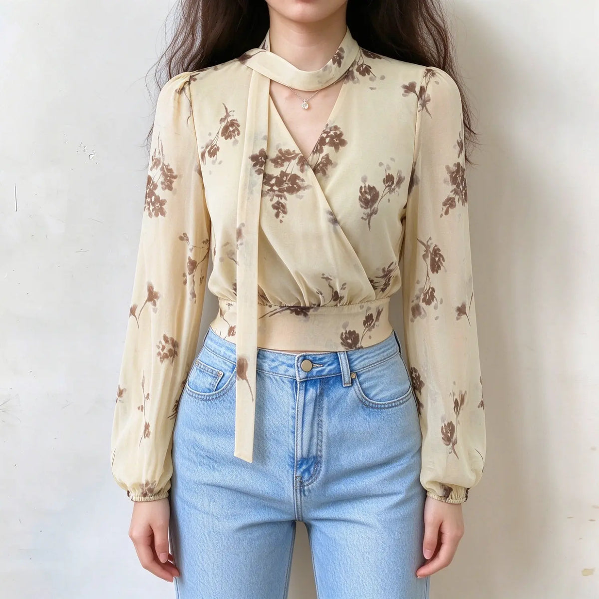 Model wearing floral print choker tie wrap blouse, front view