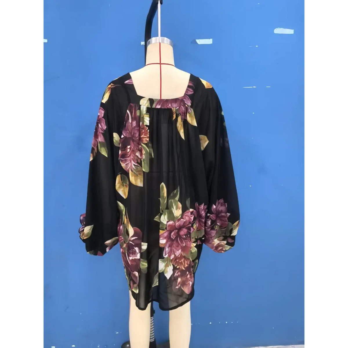 Mannequin back view of floral print blouse