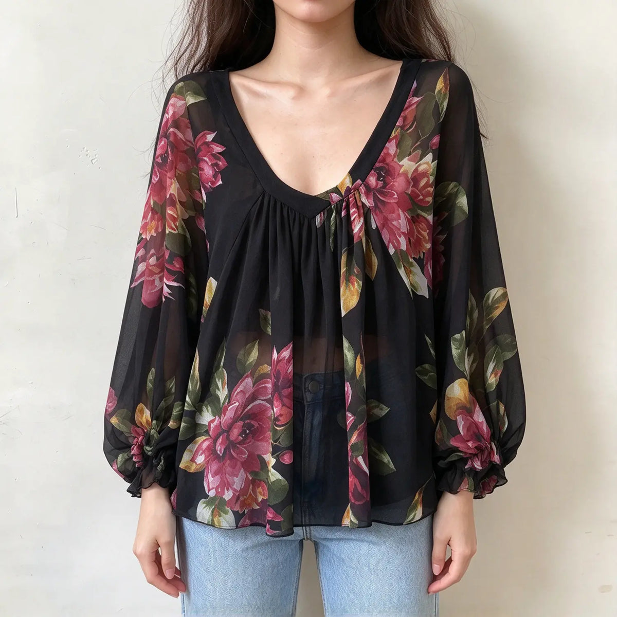 Model wearing floral print gathered v neck balloon sleeve blouse with jeans, front view