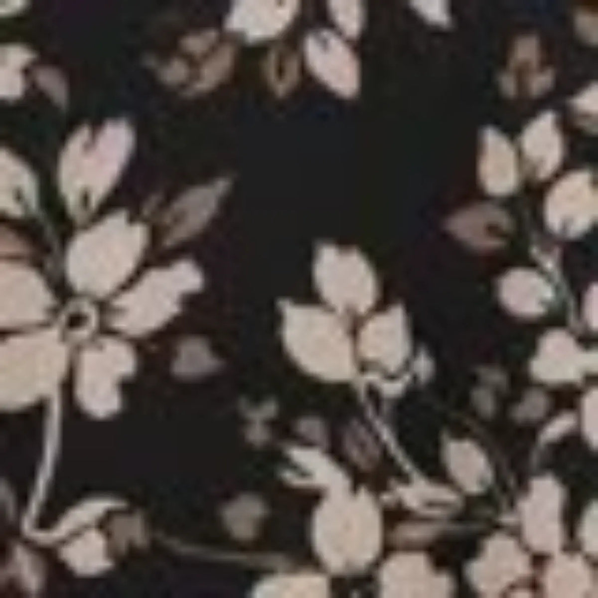 Close-up of black fabric with delicate cream floral and vine pattern