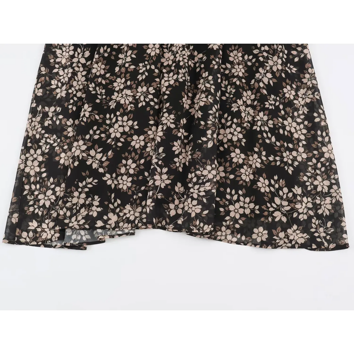 Close-up of lightweight black floral fabric with pink and brown blossoms and draping folds