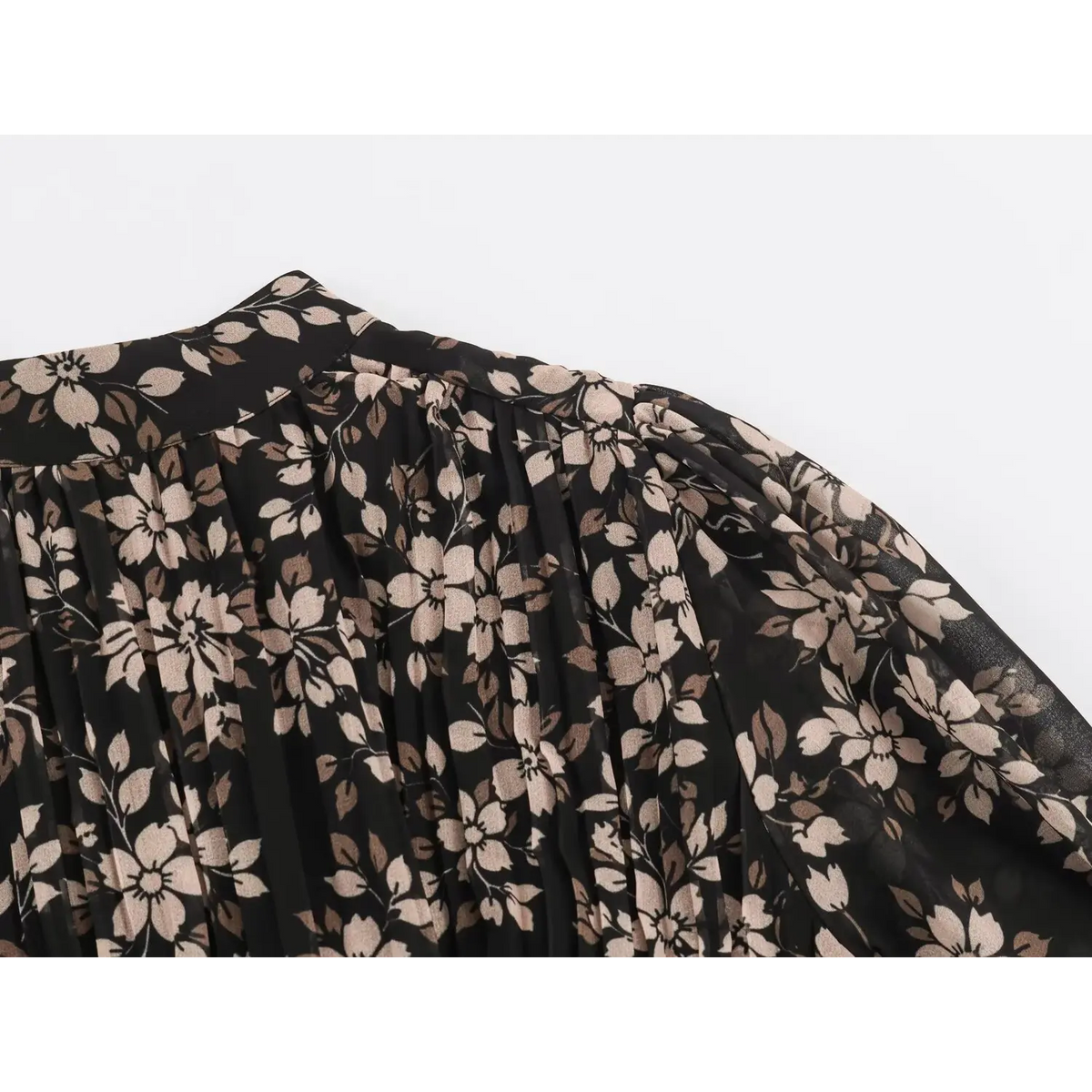 Close-up of stand collar and sleeve of black floral print dress with cream flowers and foliage