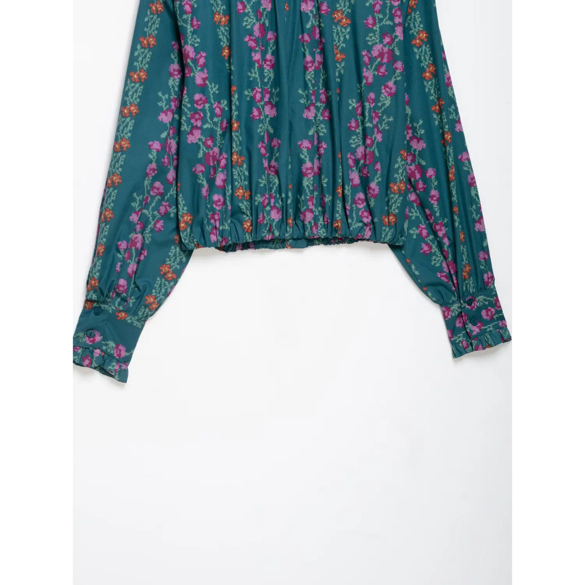 Back flat lay showing shirred hem and cuffs