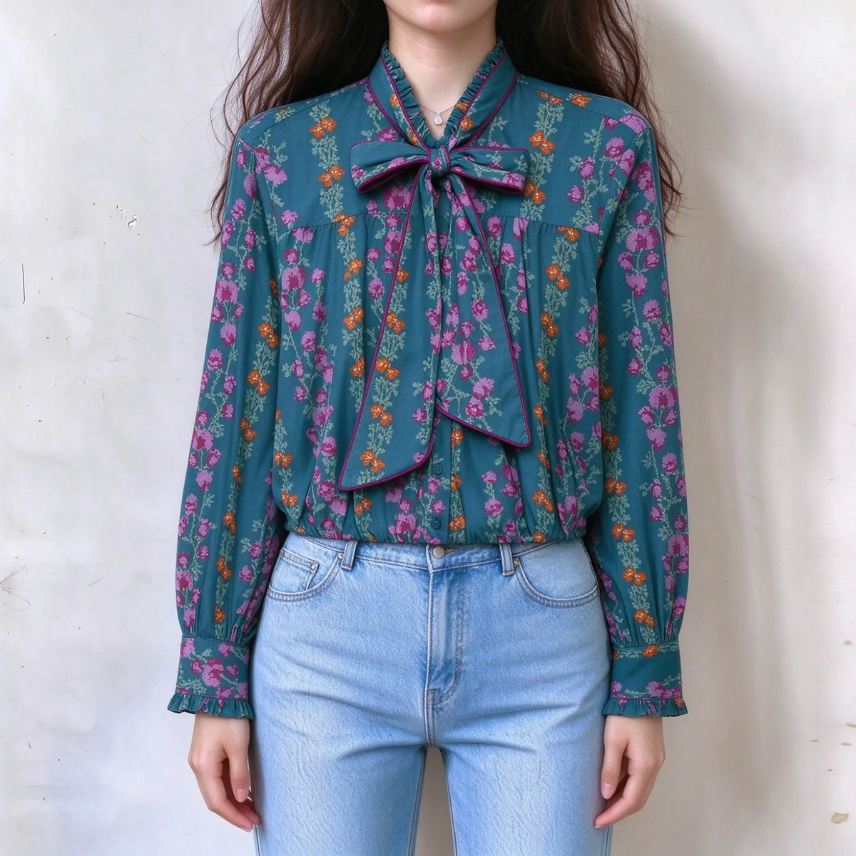 Model wearing floral print tie neck ruffle blouse, front view