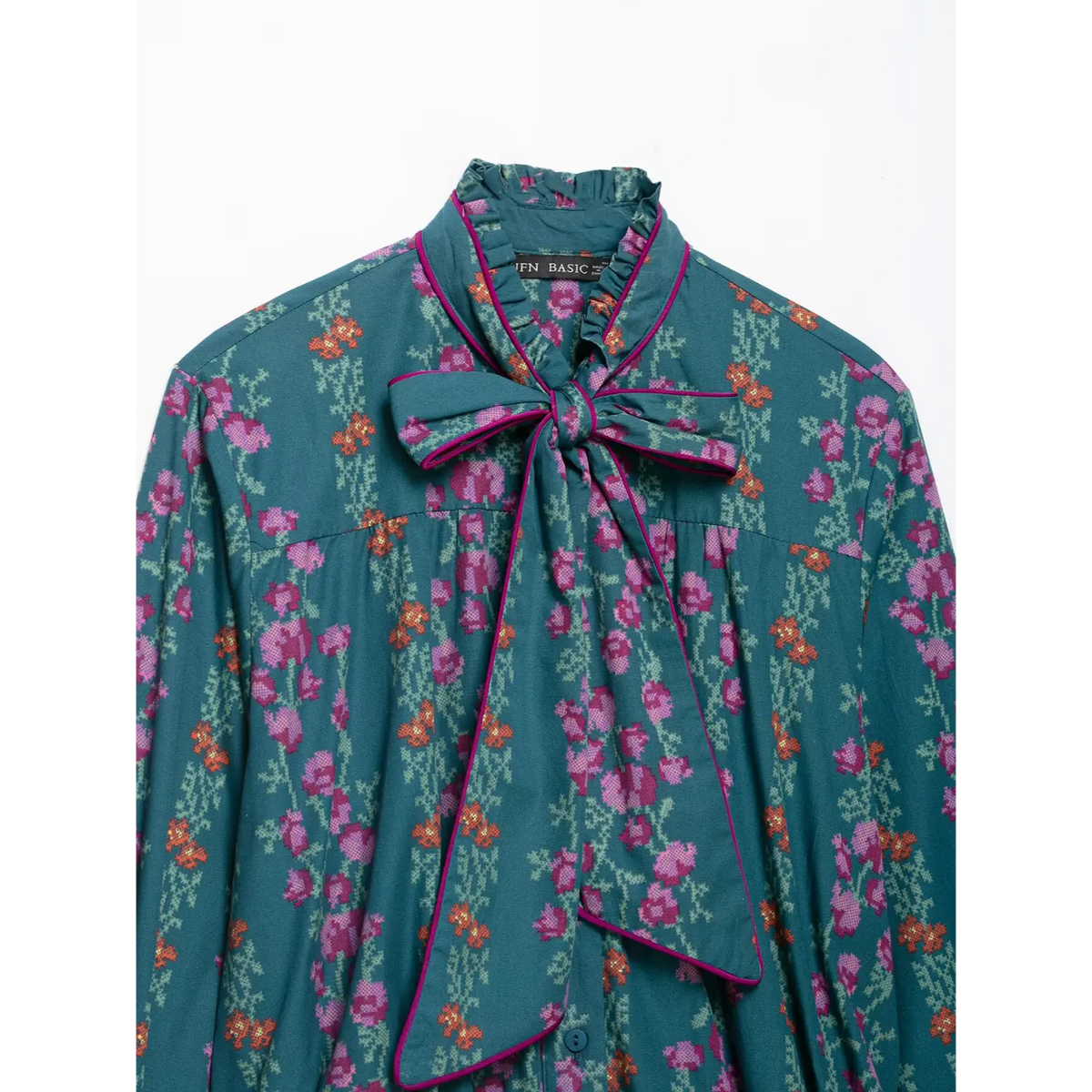 Close-up of ruffle collar and tie bow