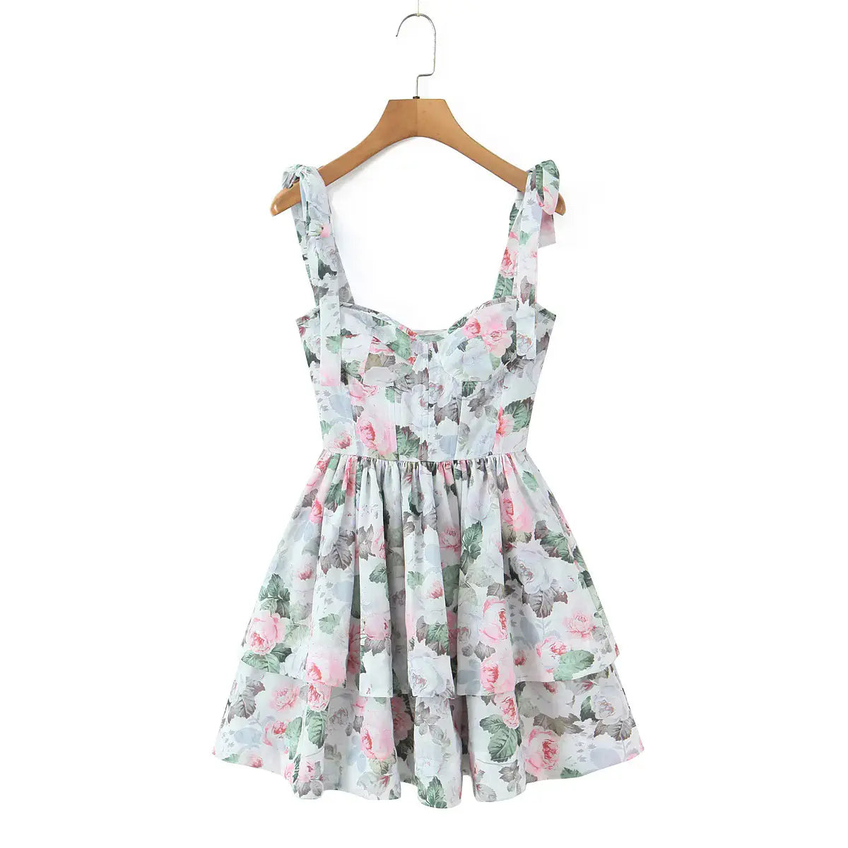 Front view of a floral print corset dress with tie straps, lace-up back, and tiered skirt.