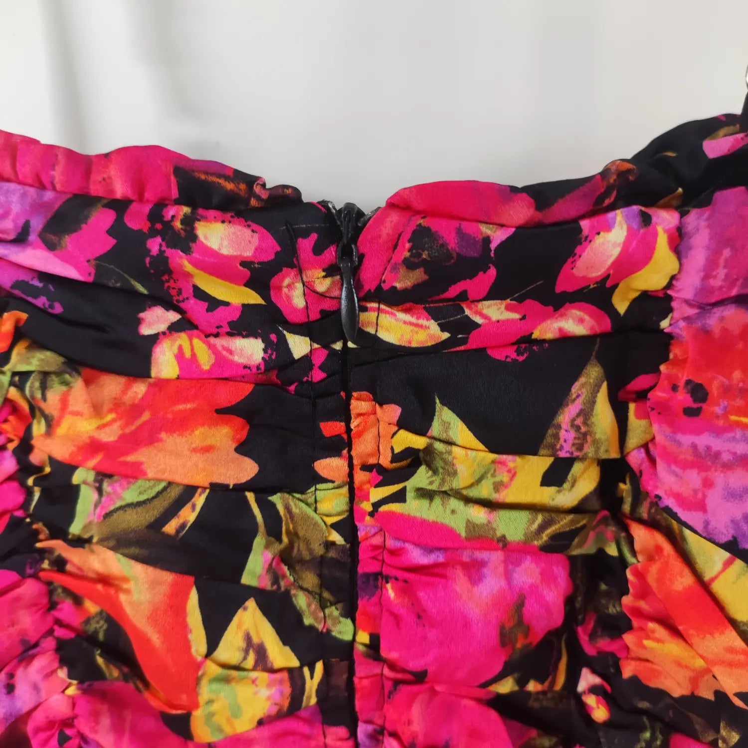 Close‑up back center zipper construction vibrant floral ruched cami mini dress