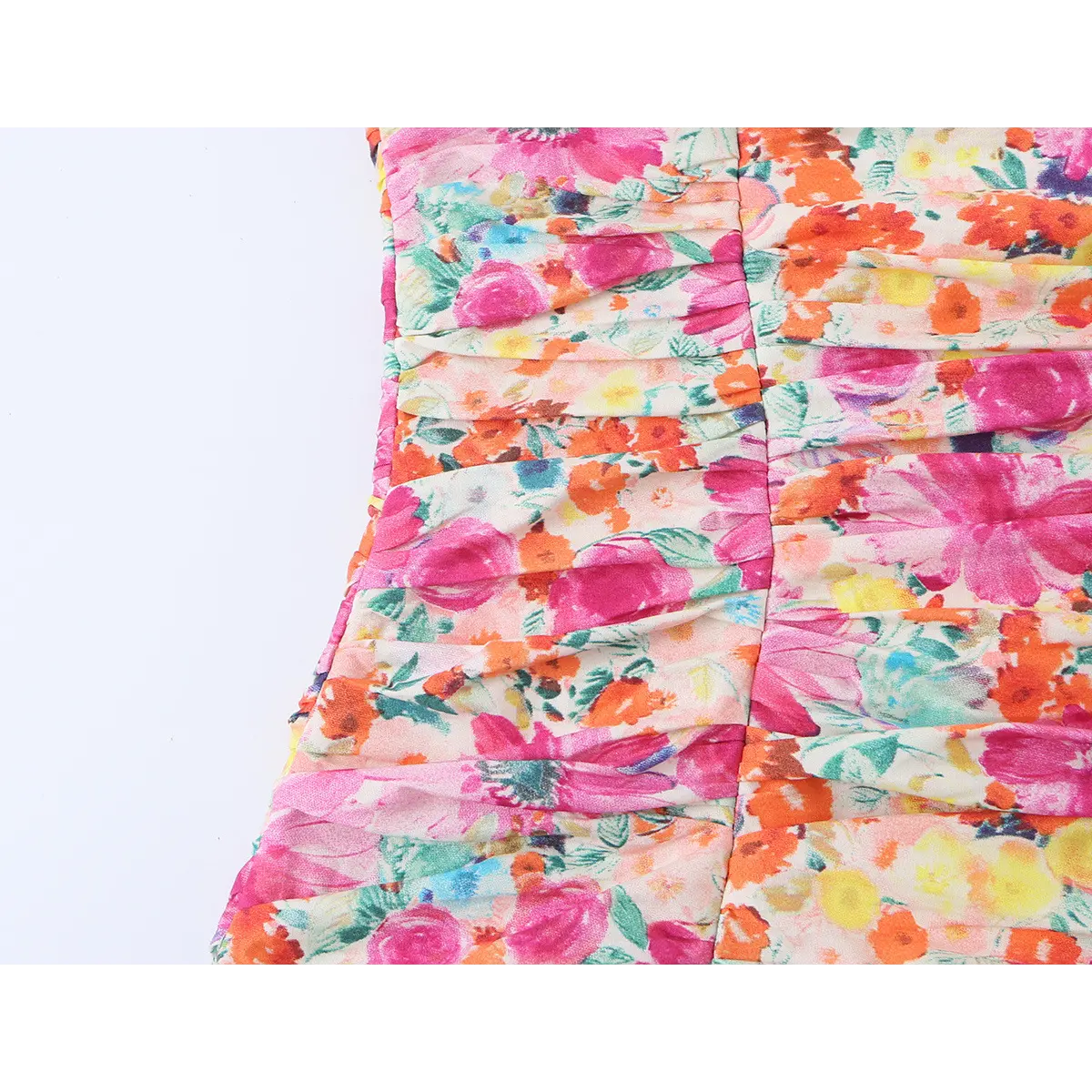 Close-up of the dress's bodice, showing all-over ruched fabric with a vibrant watercolor floral print.