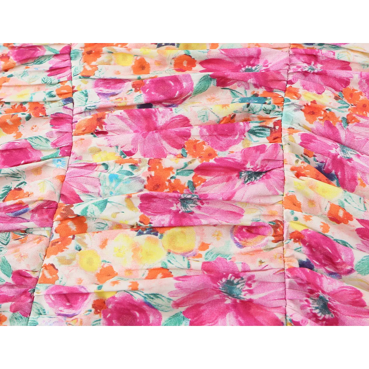 Close-up of the dress's fabric, highlighting the watercolor floral print and ruched texture.