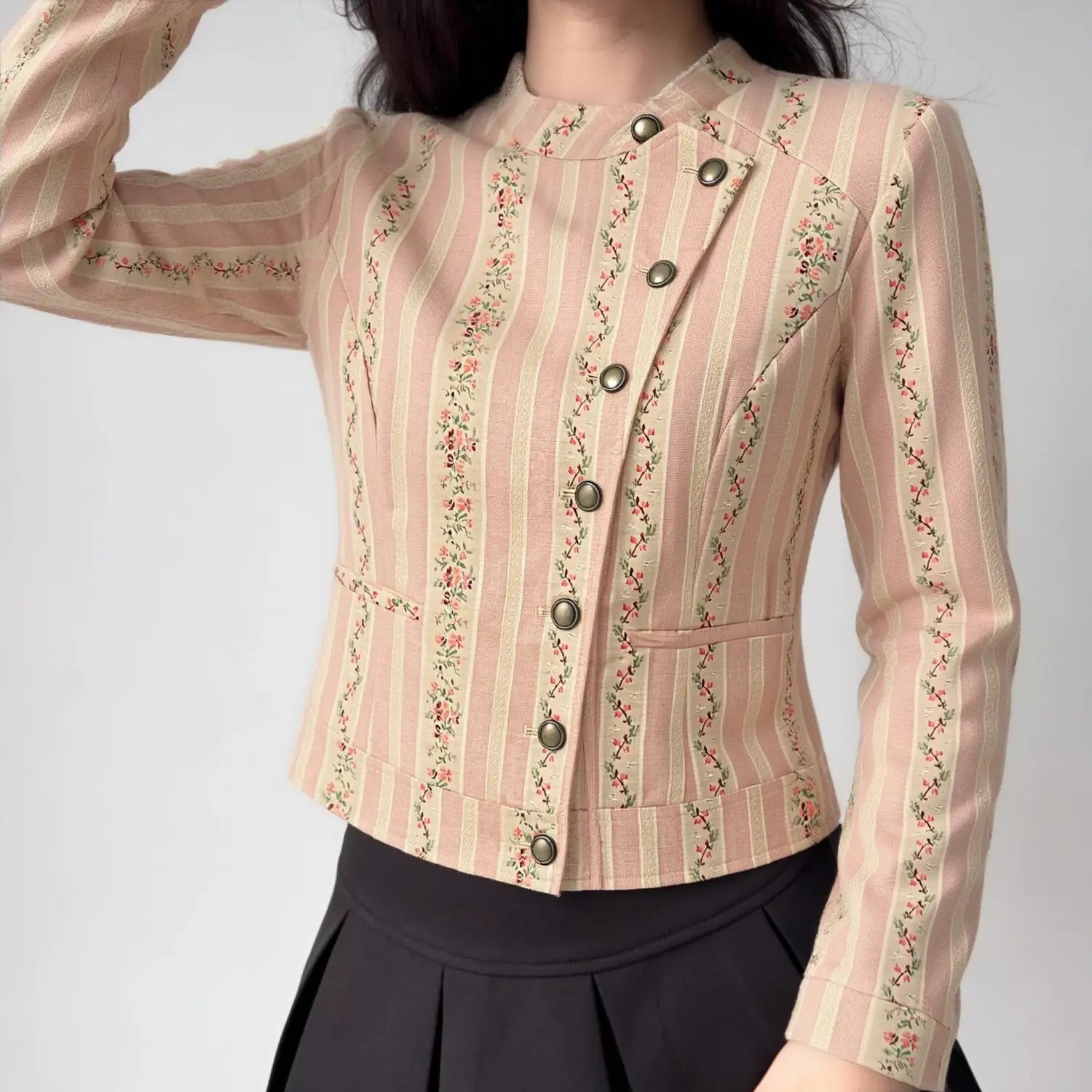 Model wearing pink floral striped stand collar cropped jacket, asymmetrical metal button front view outfit