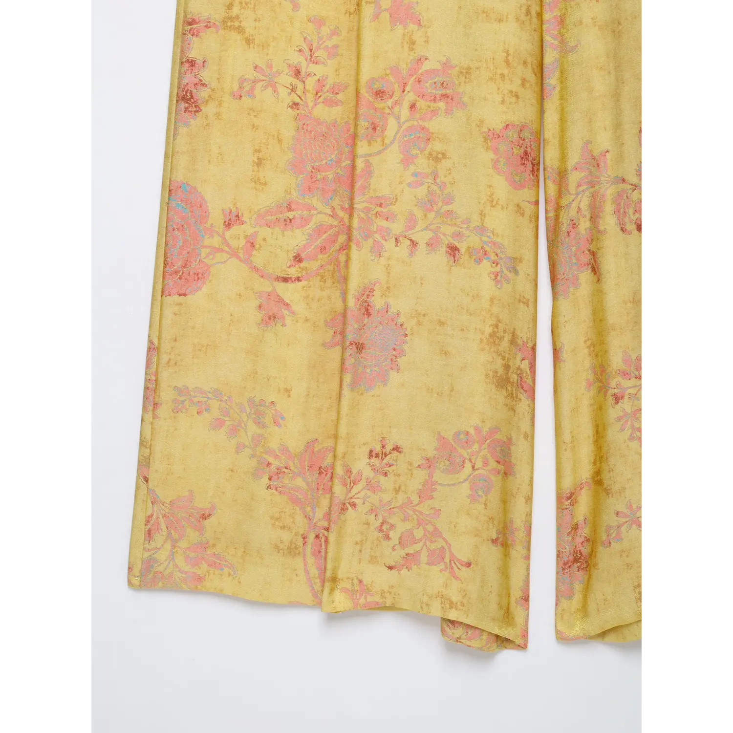 Lower leg fabric close-up, faded pink flower print yellow loose wide leg bottoms