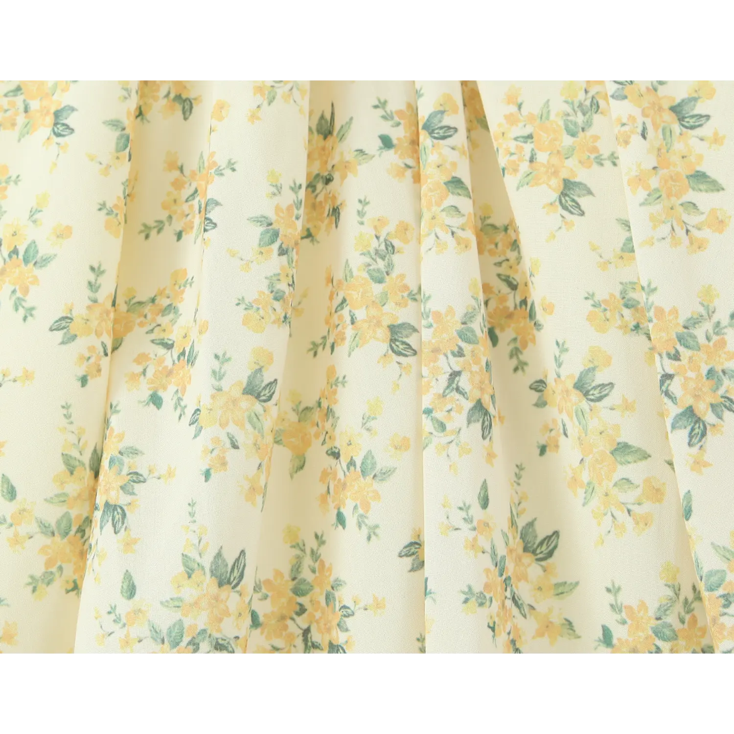 Fabric texture close‑up, yellow small flower and green leaf print on lightweight dress material