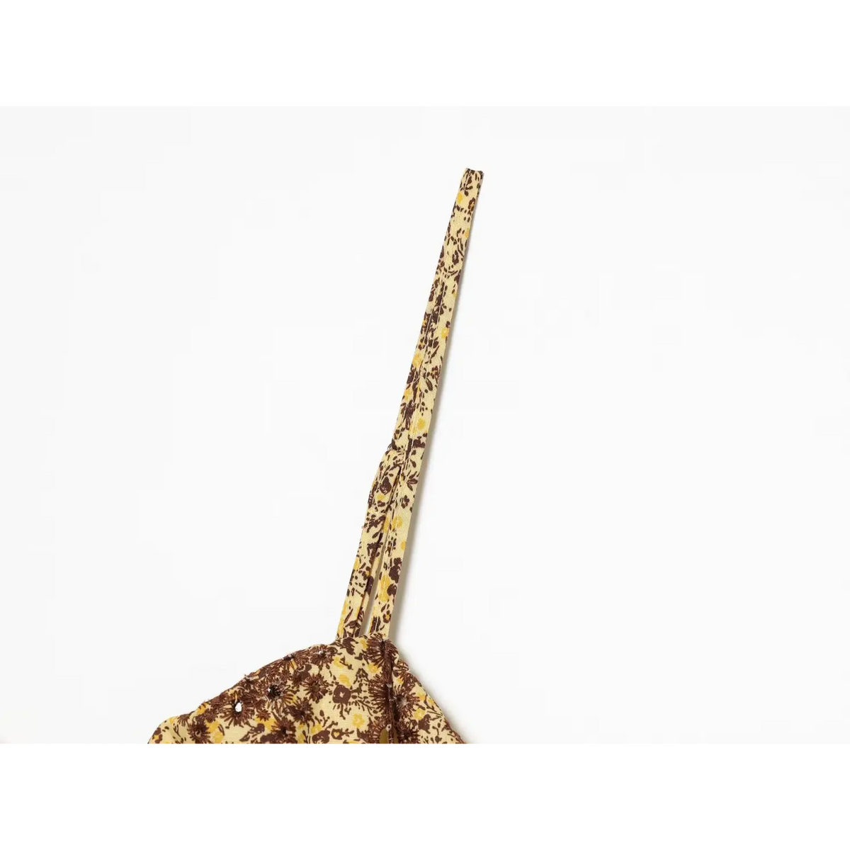 Close‑up of printed spaghetti strap of yellow brown floral midi dress
