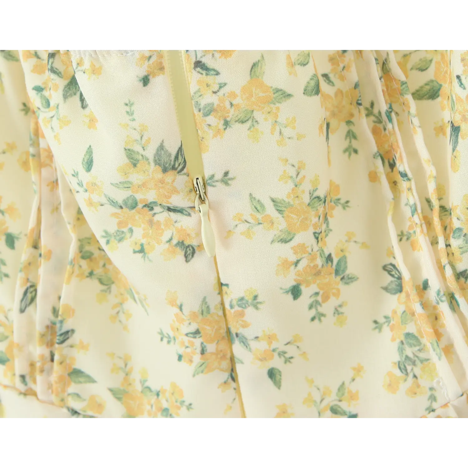 Close‑up of hidden back zipper on yellow floral halter mini dress with floral fabric