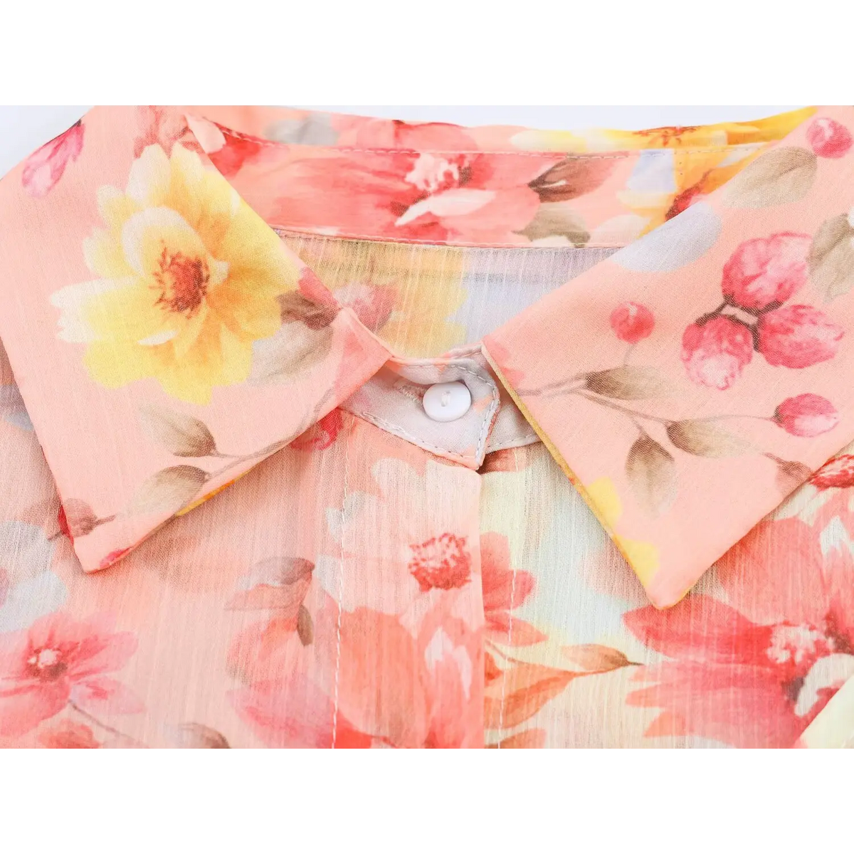 Macro view of shirt collar and white front button on watercolor print maxi dress