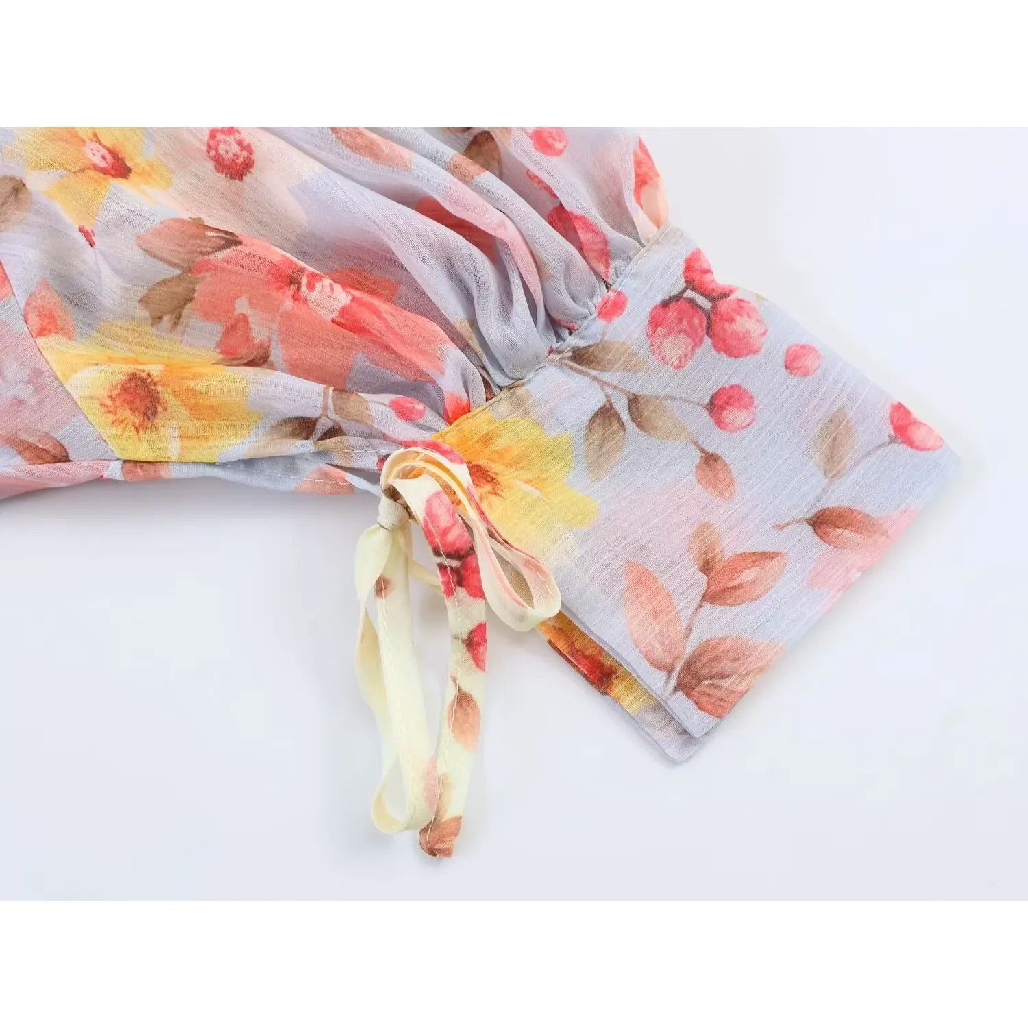 Close‑up of sleeve cuff with self‑fabric tie on balloon sleeve maxi dress