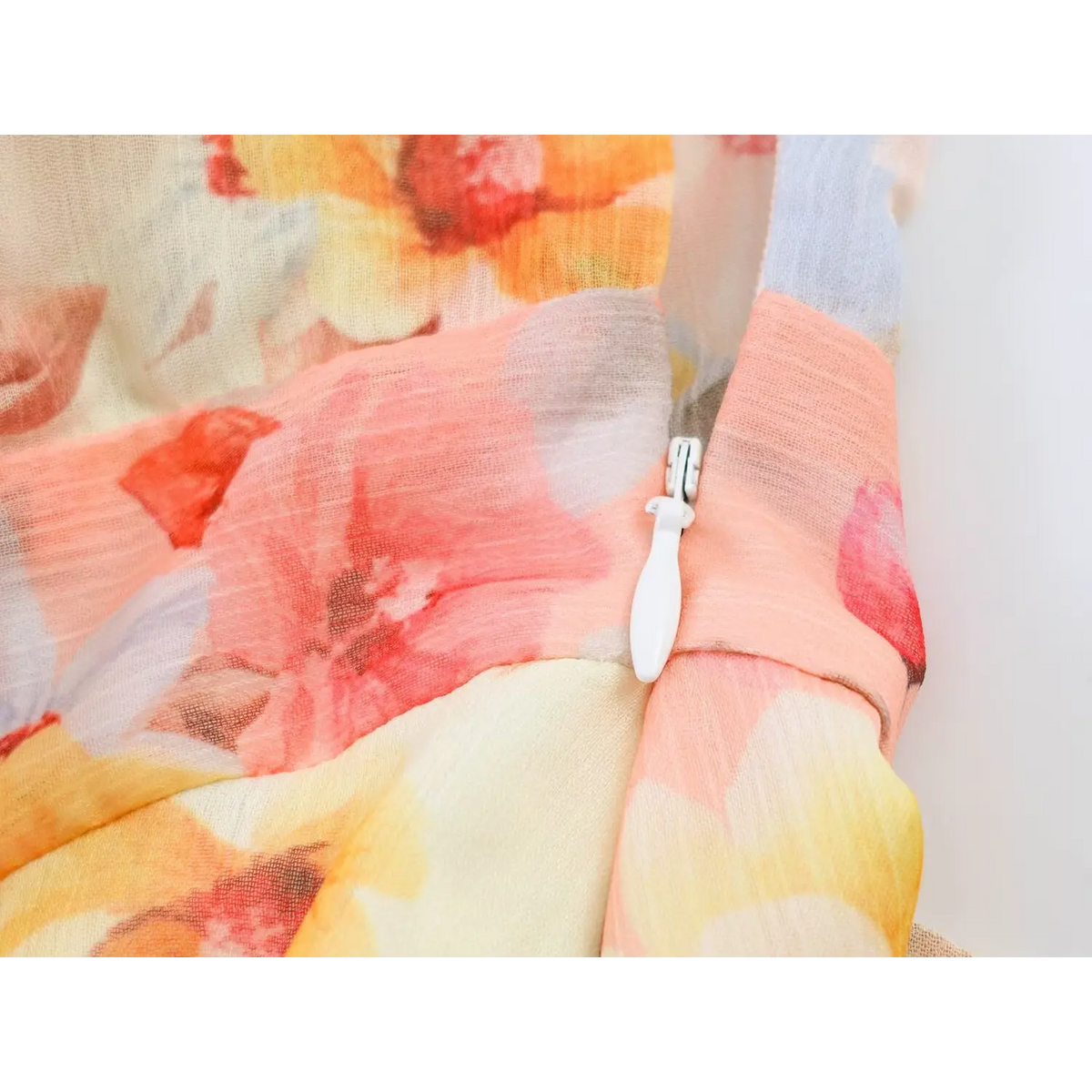 Macro shot of invisible side zipper on patchwork floral print maxi dress