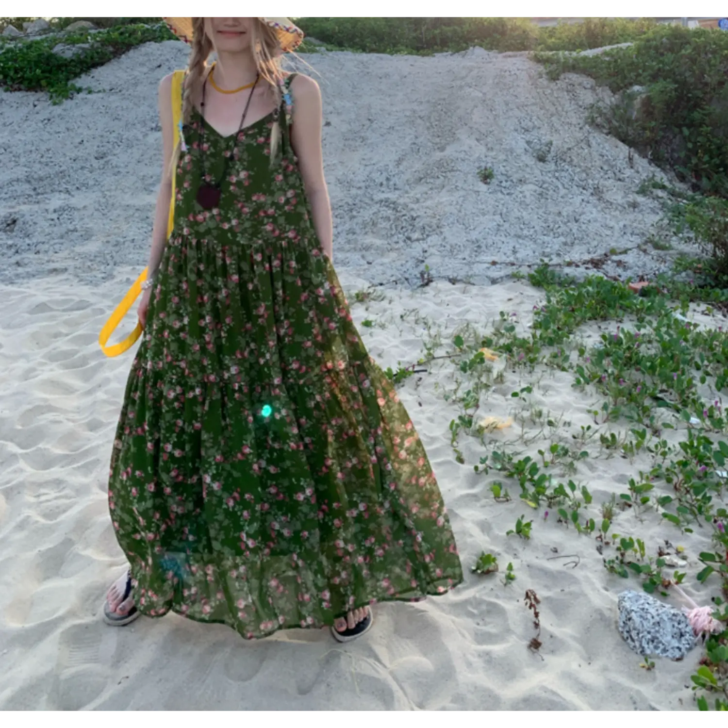 Sunny beach sand full front shot of dark green pink micro floral tier maxi slip dress, flowy layered long skirt, straw wide brim hat, black slide flip flops