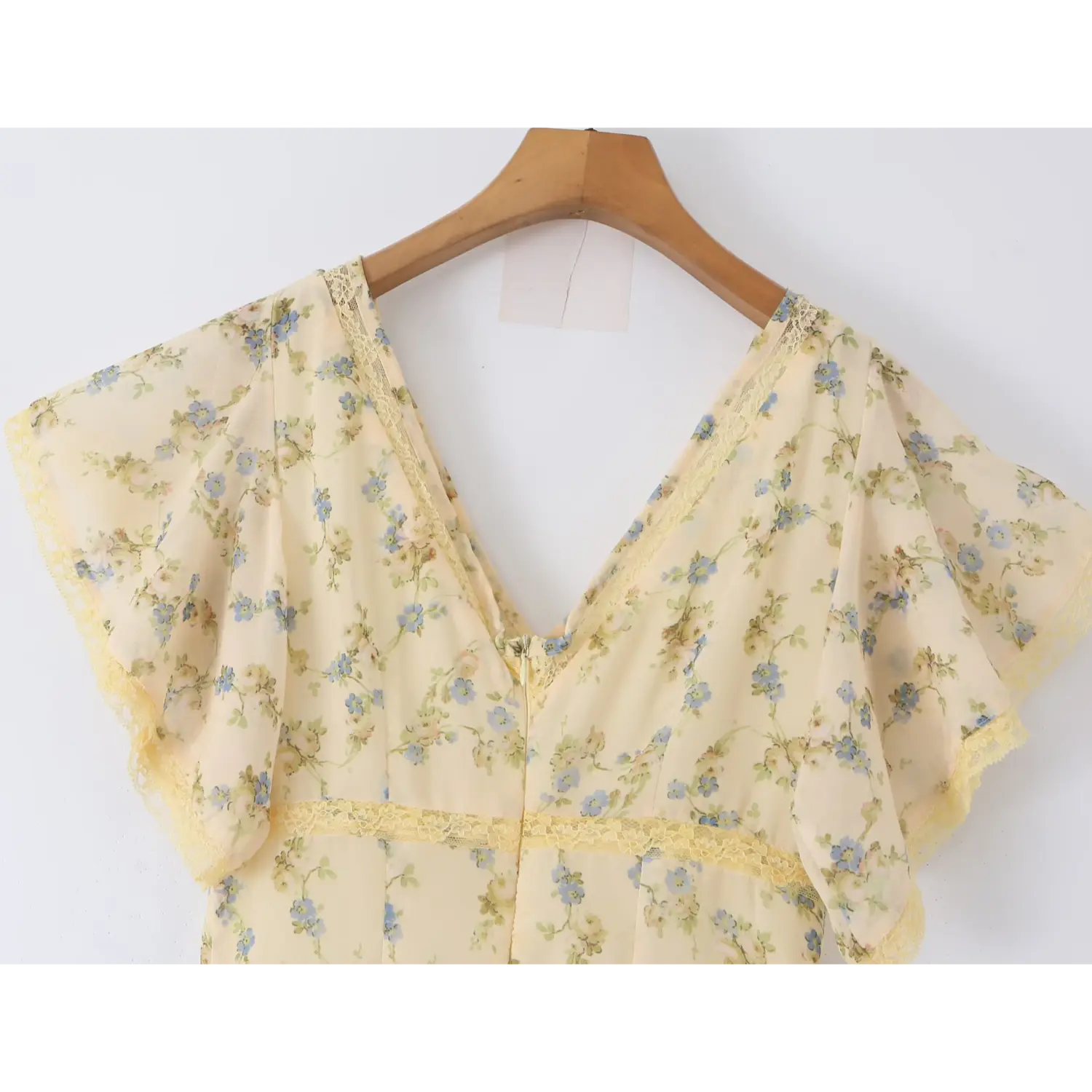 Hanging medium shot of full v-neck flutter sleeve bust, continuous yellow lace trim matching cream base blue floral chiffon mermaid dress