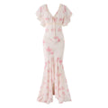 Full front white background shot of pink rose floral chiffon mermaid maxi dress, lace trimmed v-neck flutter sleeves for dating and wedding guest wear