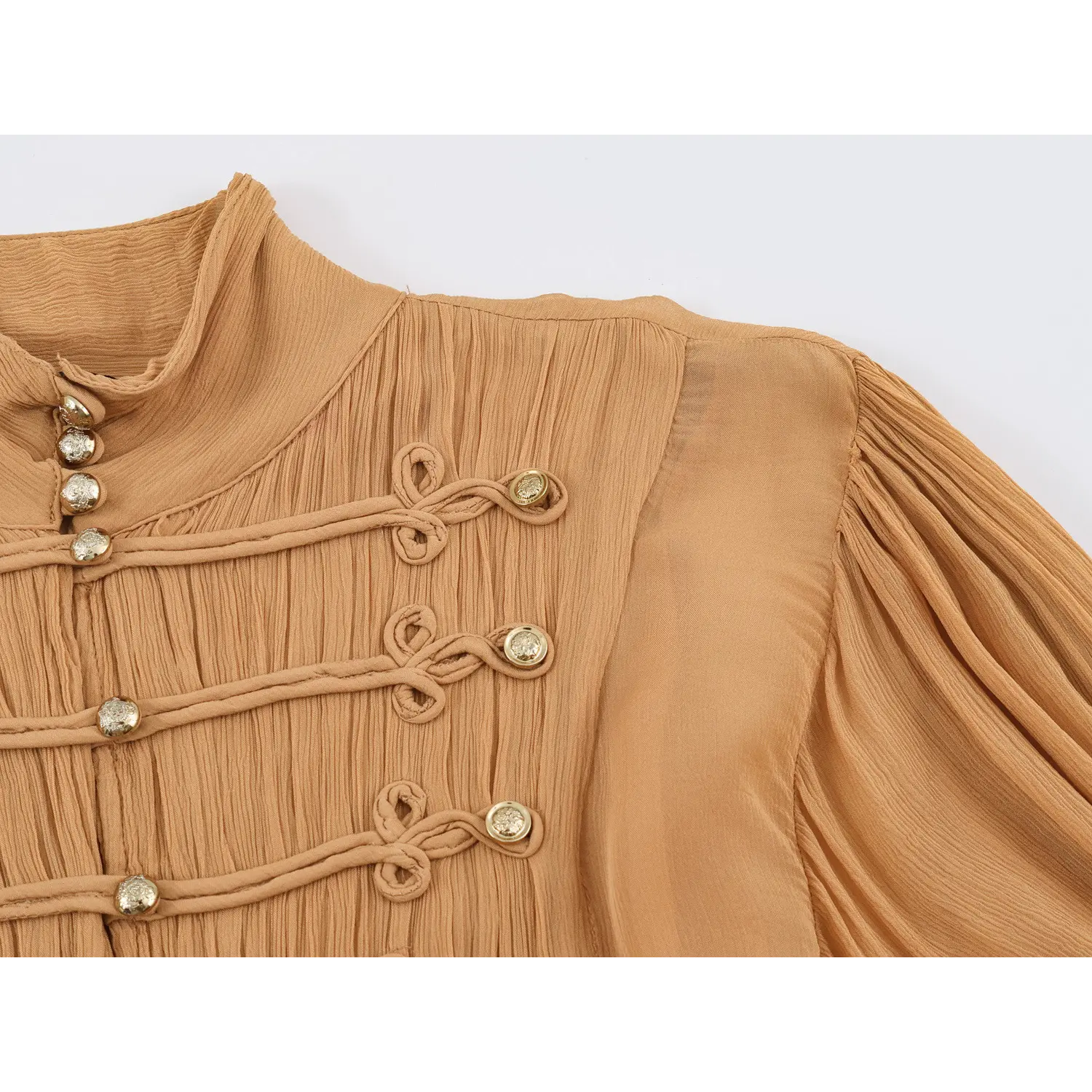 Macro detail of chest frog knot trim, gold buttons and crinkled fabric texture
