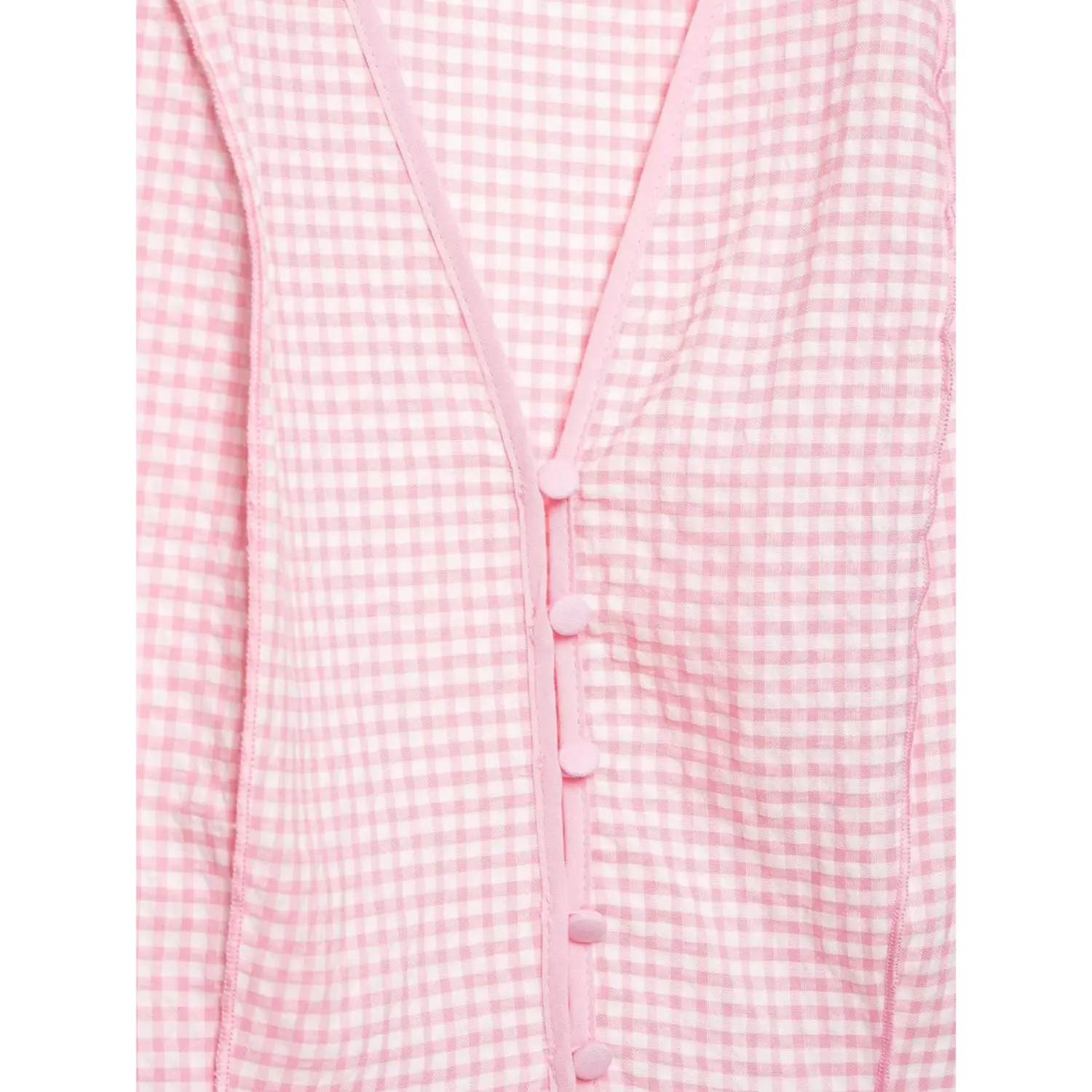 Front placket macro close-up, matching pink round fabric covered buttons, vertical seam on gingham blouse