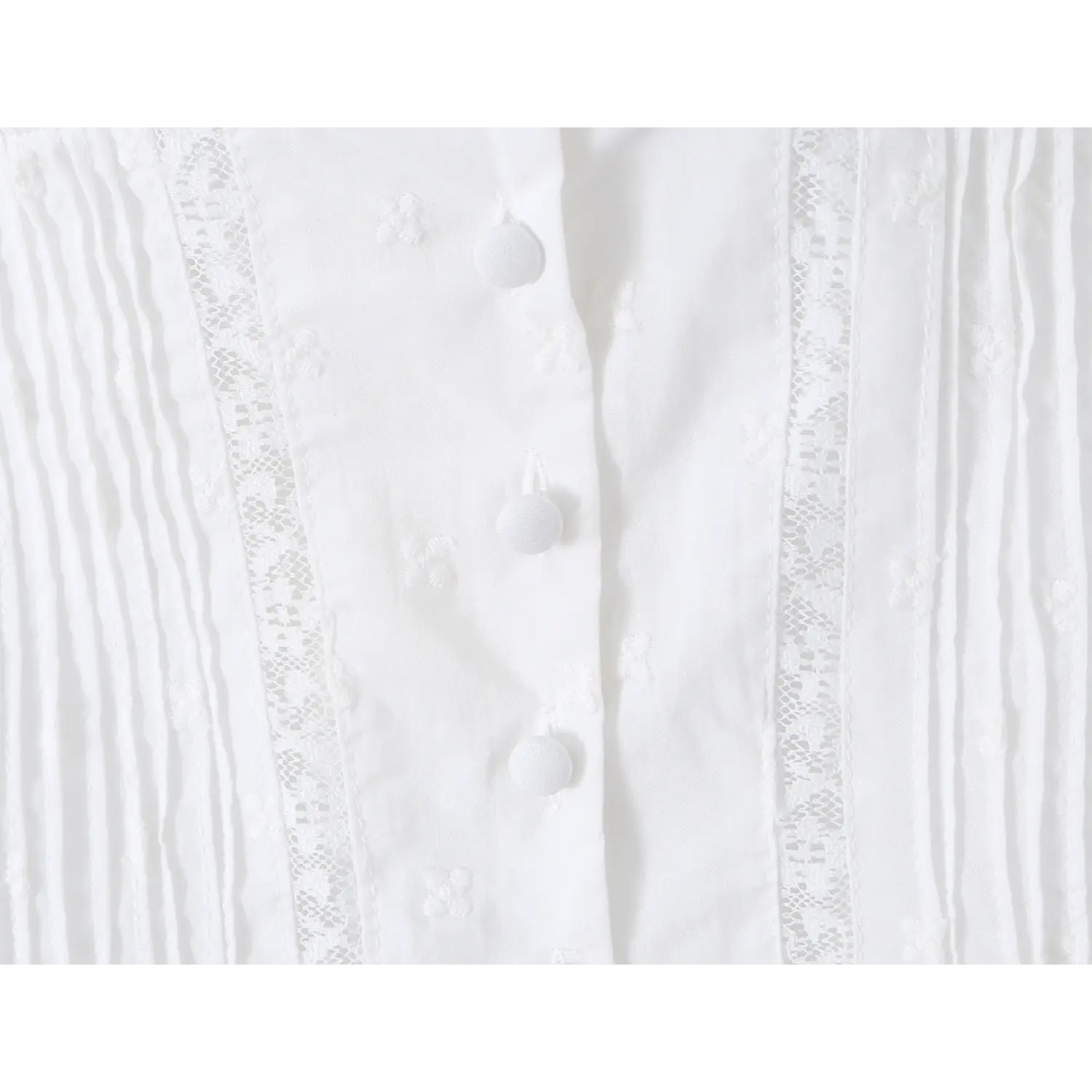 Waist front placket close up fabric covered buttons vertical pleats mesh lace panel fitted corset blouse white cotton