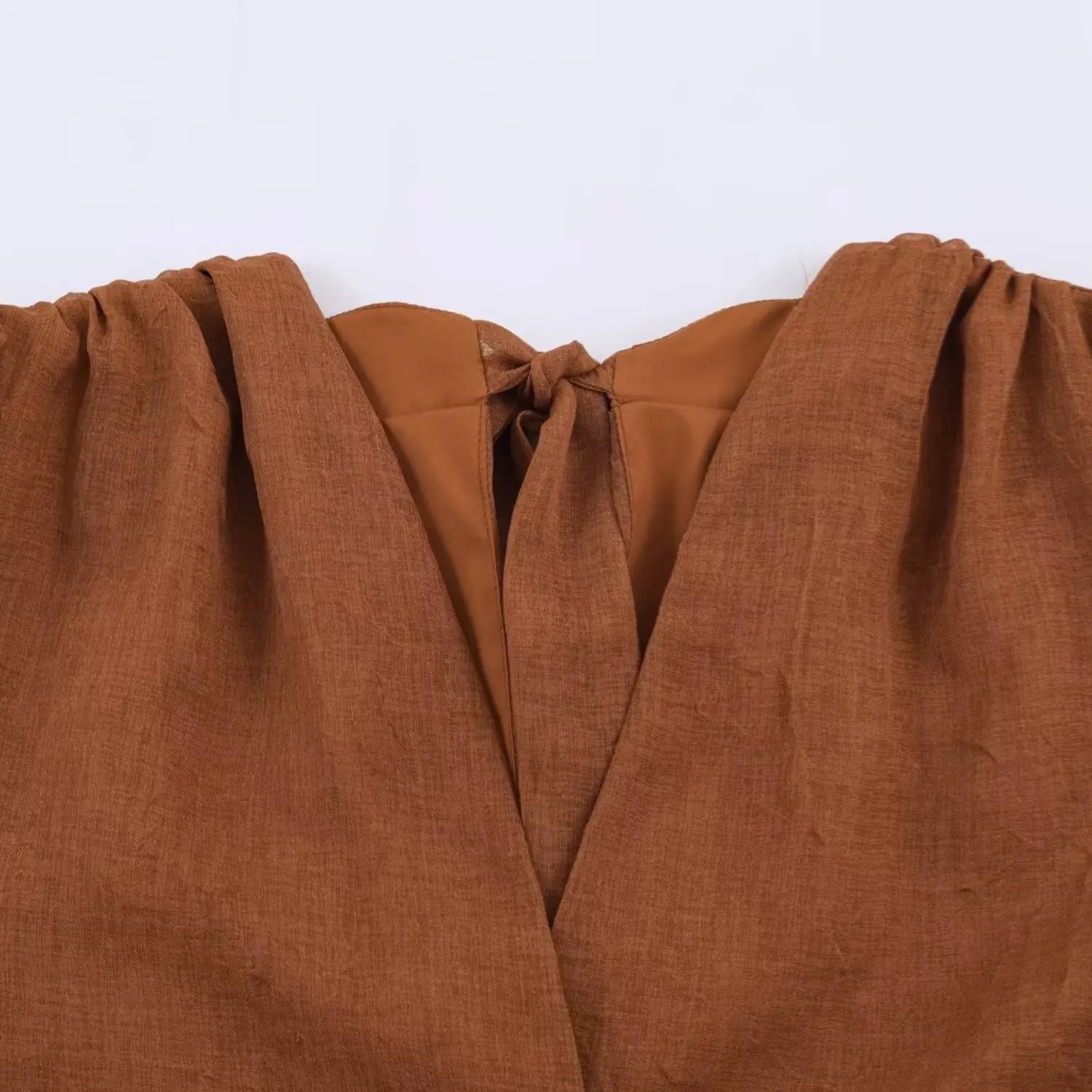Front deep V neck partial macro shot, gathered ruched bust, lightweight wrinkled coffee fabric