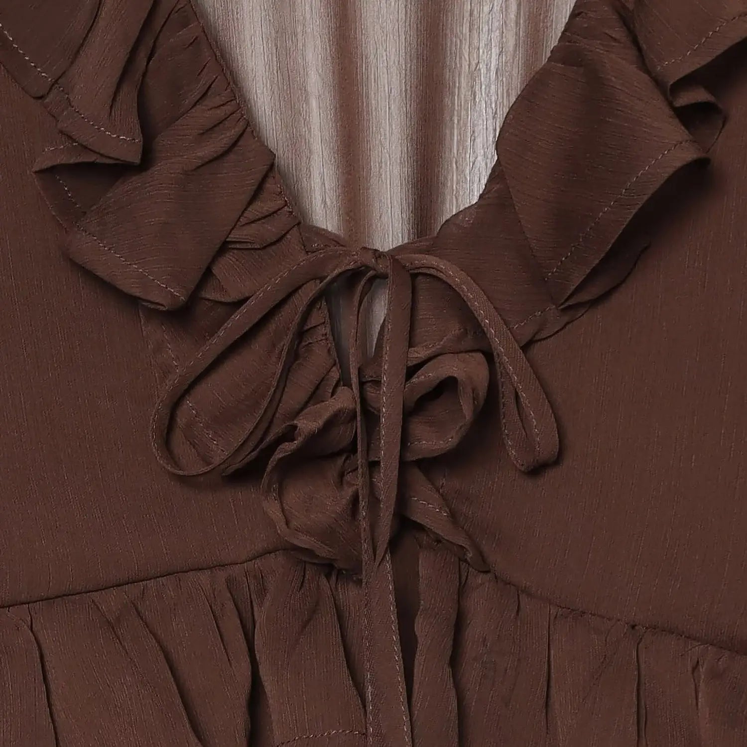 Front self fabric tie bow chiffon macro close-up, sheer crinkle fabric soft drape double ruffle neck breathable textured chiffon clear texture detail shot