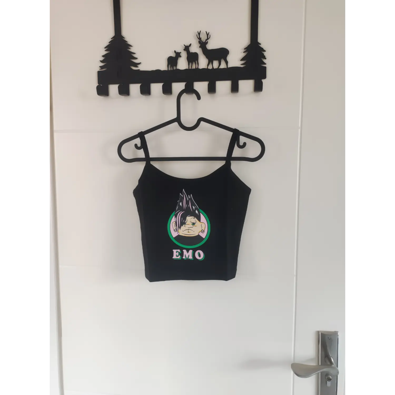 Front hanging shot black cartoon print slim fit spaghetti strap crop tank top on hanger