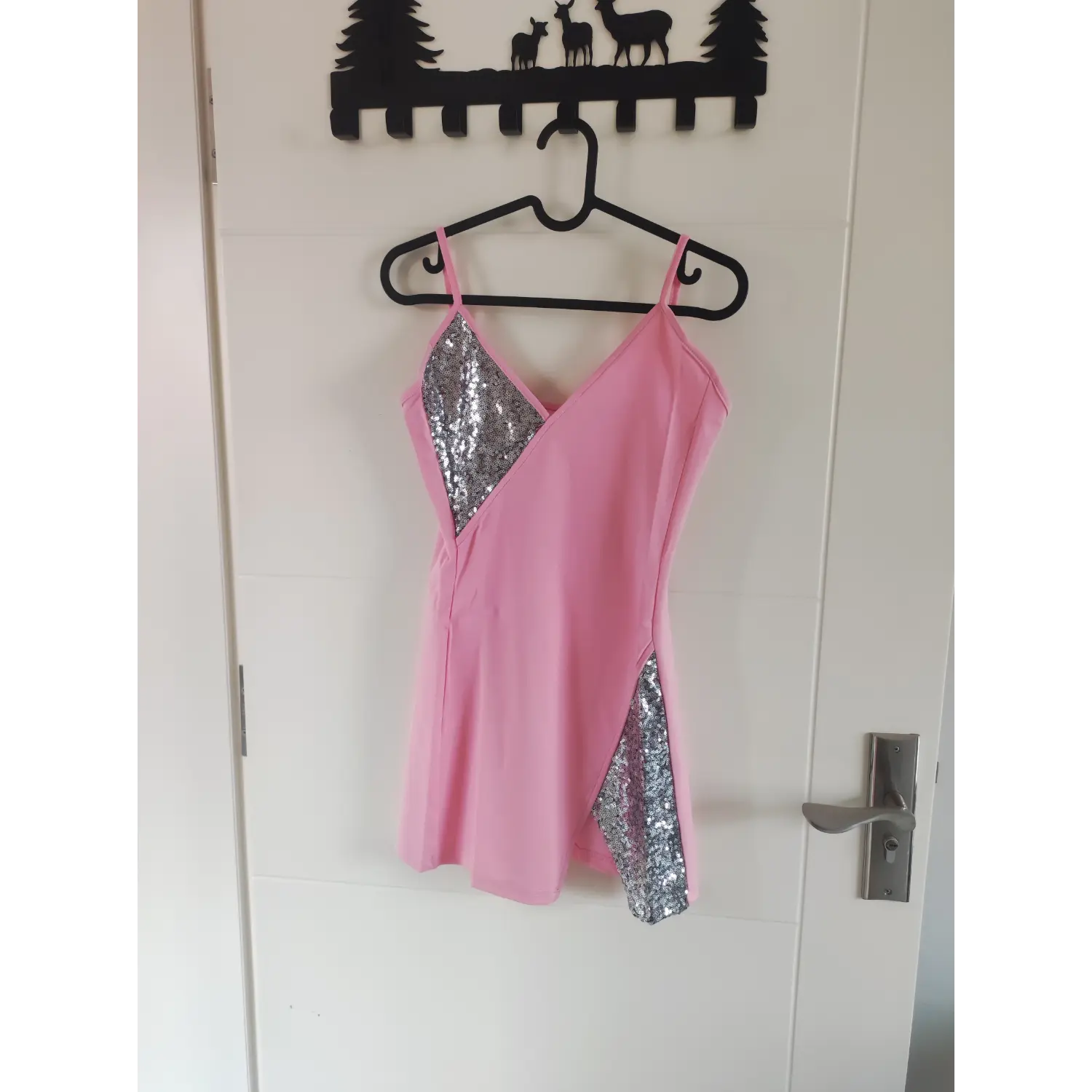 Front hanging shot pink v-neck silver sequin splice cami bodycon dress hung on black clothes hanger