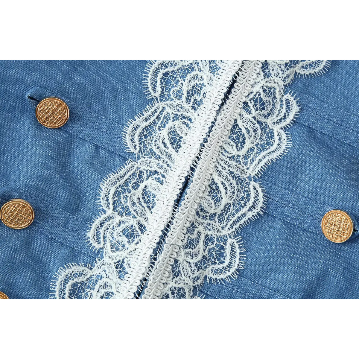 Detailed closeup of front placket, intricate white eyelash lace and embossed gold decorative buttons on blue jacket