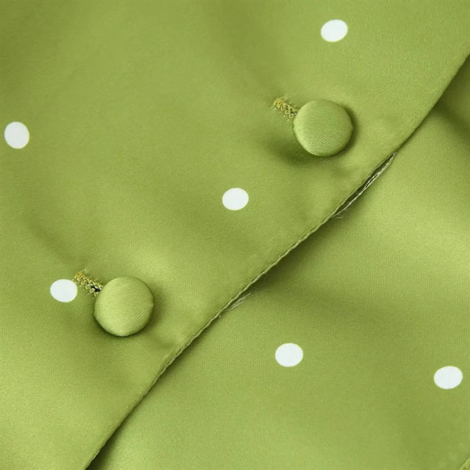 Button placket close-up, round self-covered fabric buttons, reinforced thread stitching, folded placket edge workmanship