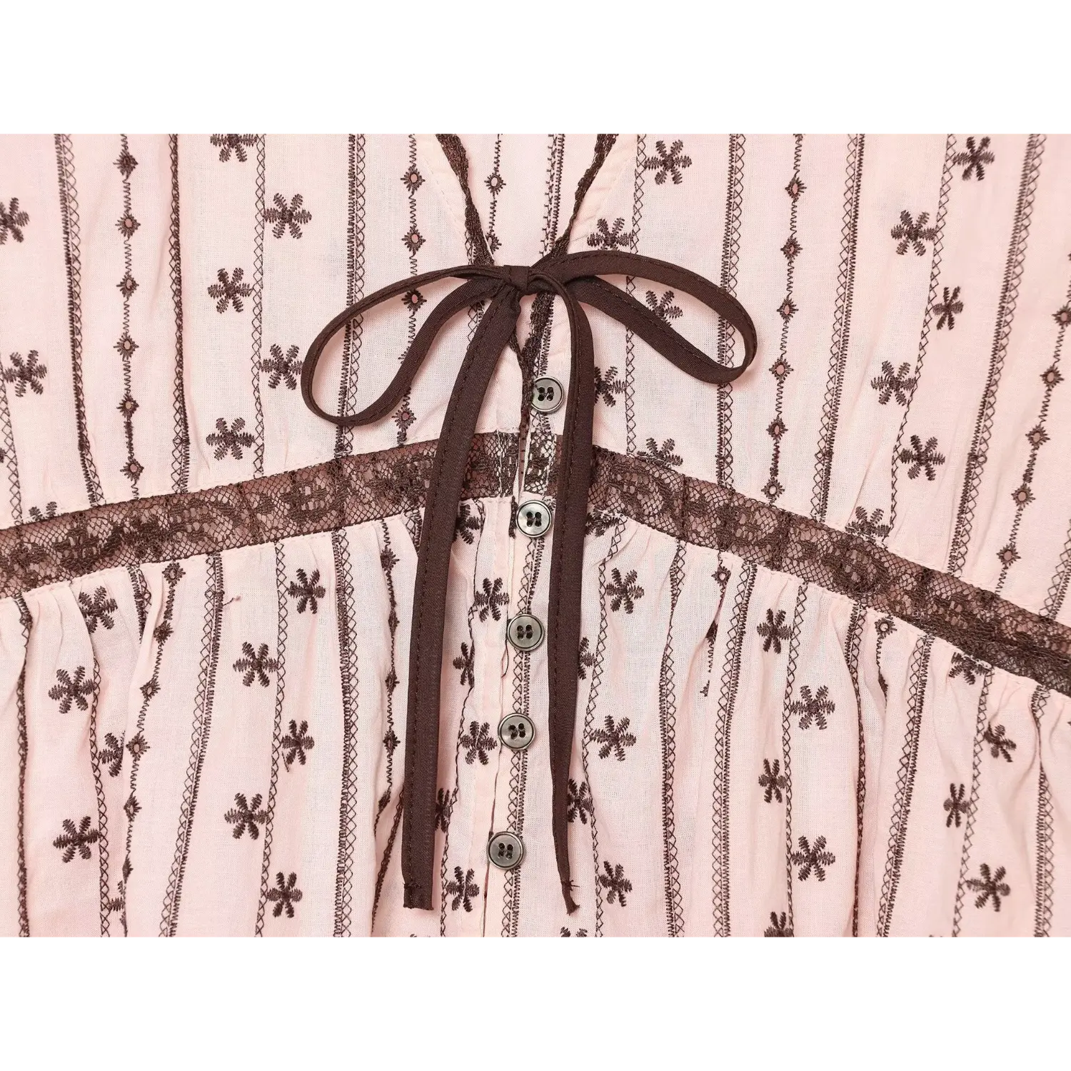 Mid torso shot, brown fabric tie bow, vertical metal buttons, horizontal hollow lace splicing at natural waist