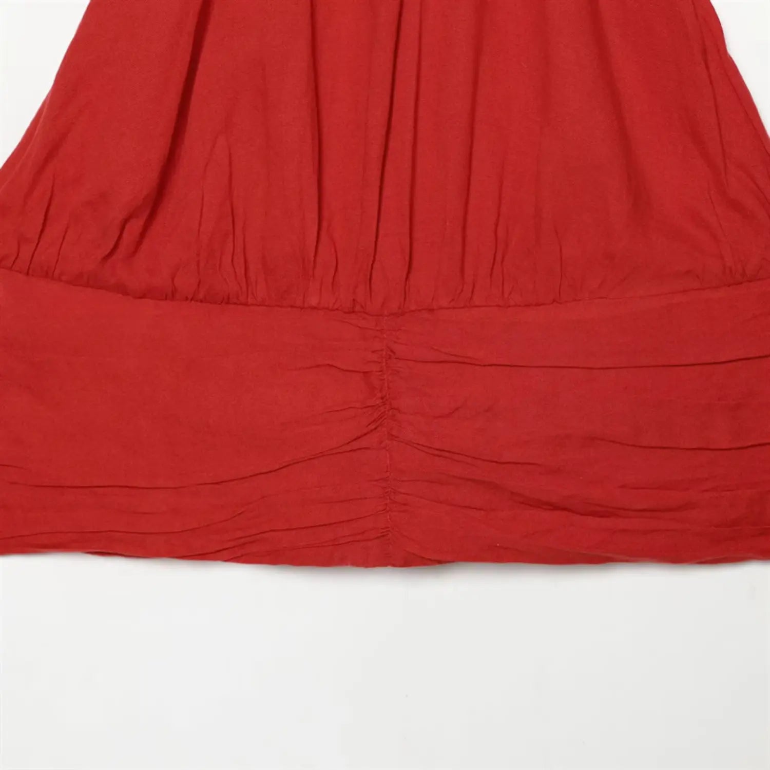 Front waist close-up, central vertical drawstring ruched panel, layered waist shaping, natural fabric folds