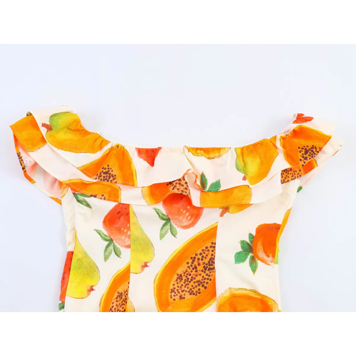 Close-up view of the ruffled off-shoulder neckline on fruit print dress, showing layered fabric design.