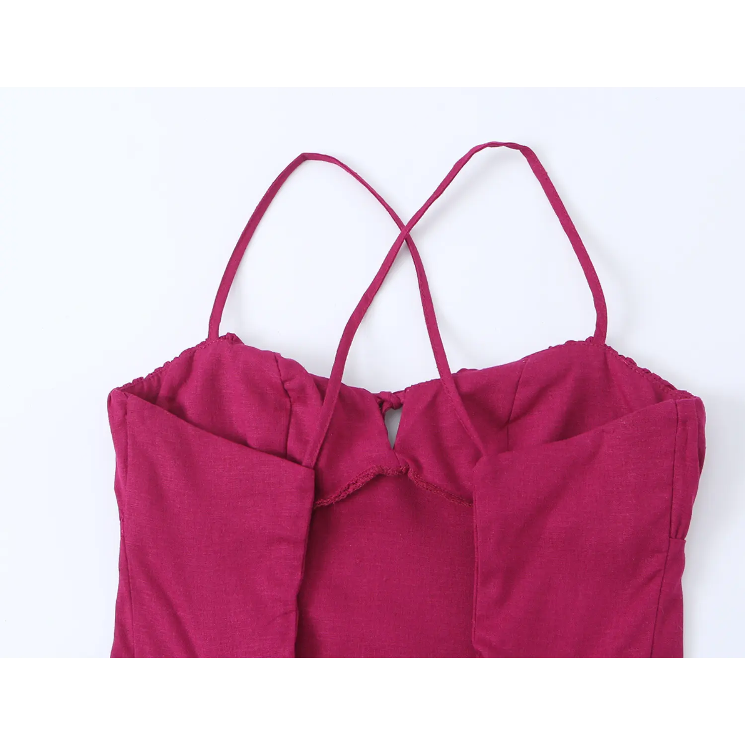 Close-up of back cutout and lace-up tie design on fuchsia maxi dress