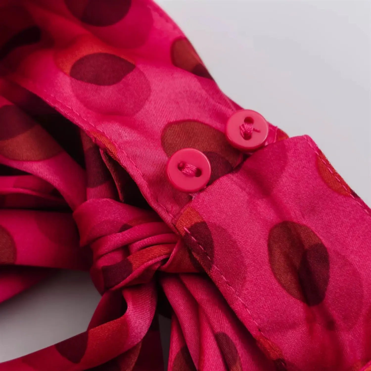 Back neck fastening close-up, two matching fuchsia fabric covered round buttons, neat placket stitching