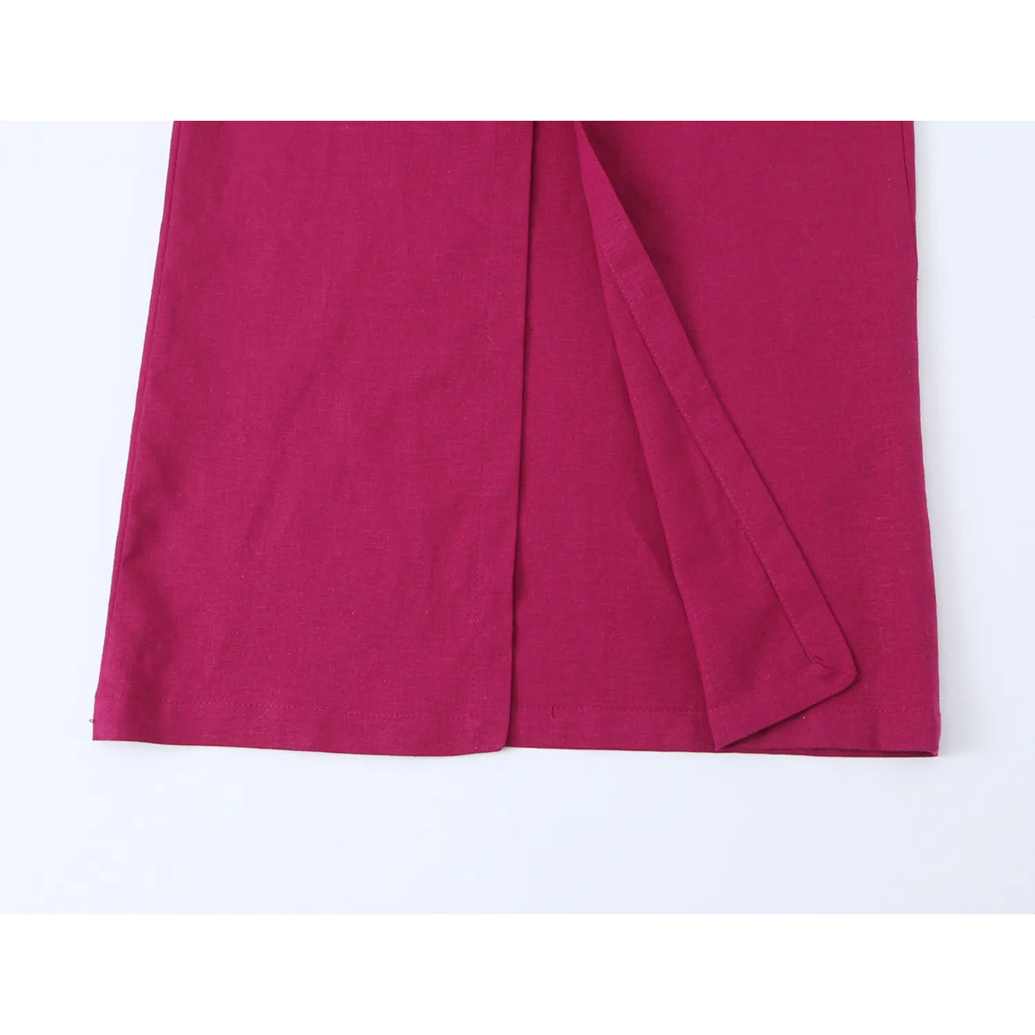 Close-up of rear hem side slit on fuchsia spaghetti strap long dress