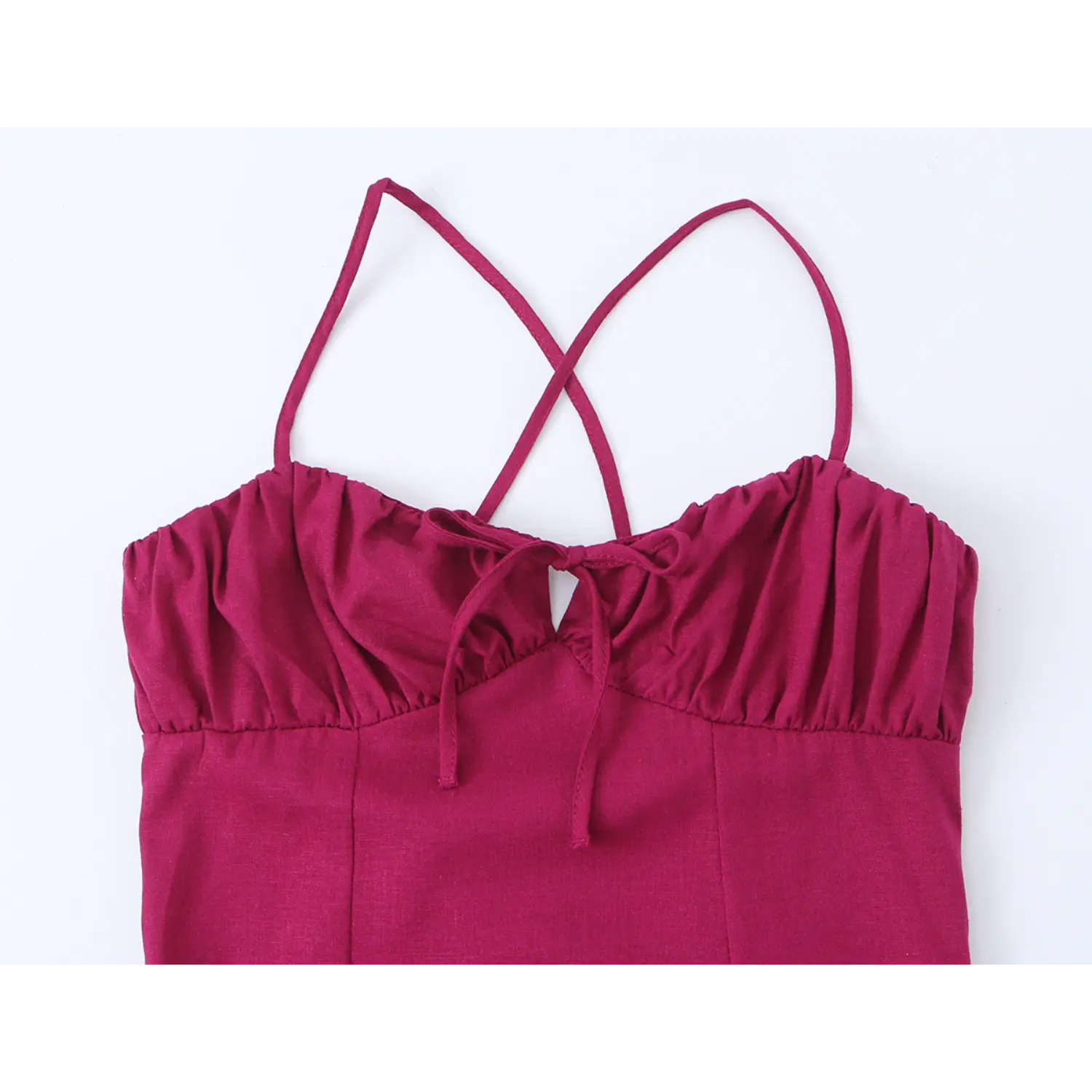 Close-up of gathered bust and front tie detail on fuchsia cross strap maxi dress