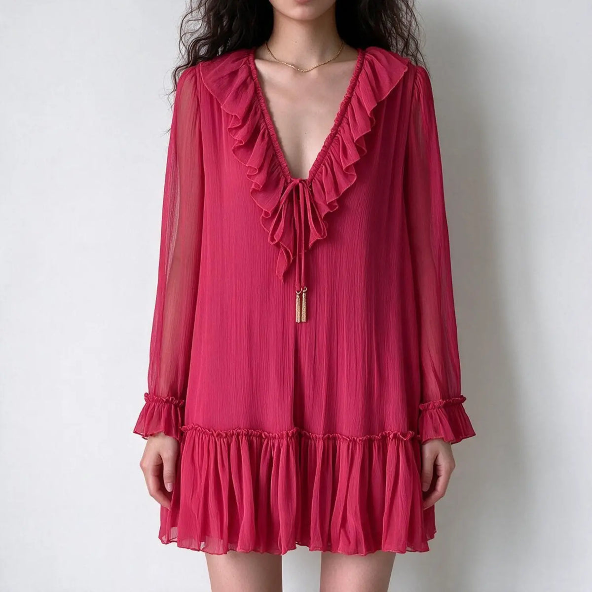 Model wearing fuchsia tie neck ruffle tiered mini dress, front view