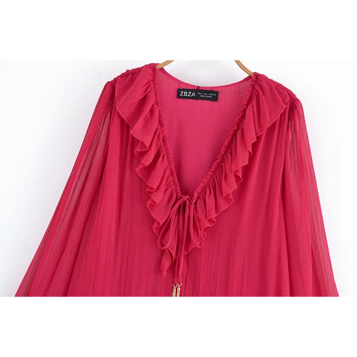 Close-up of V neckline ruffle and tie neck on hanger