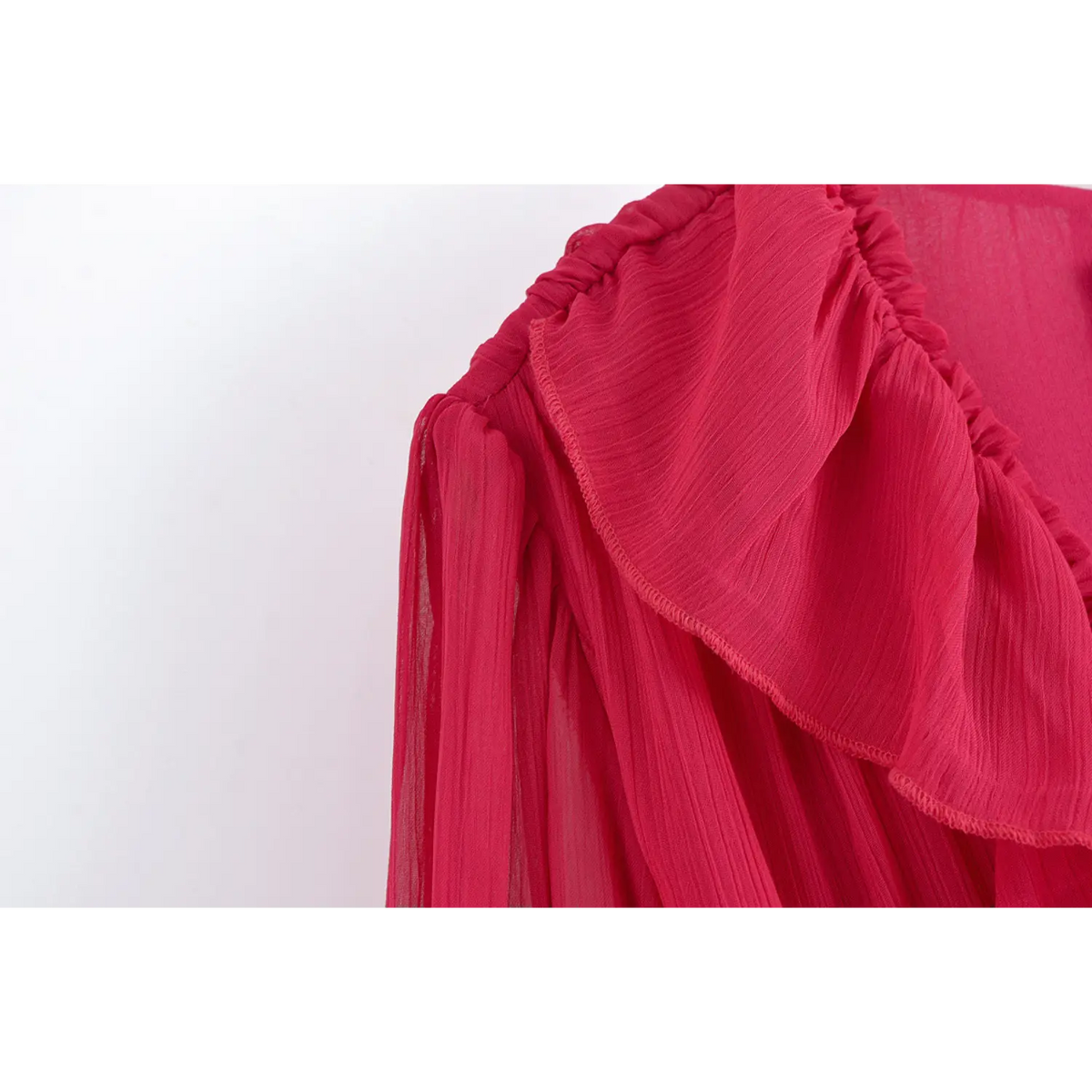 Close-up of shoulder ruffle and sheer sleeve