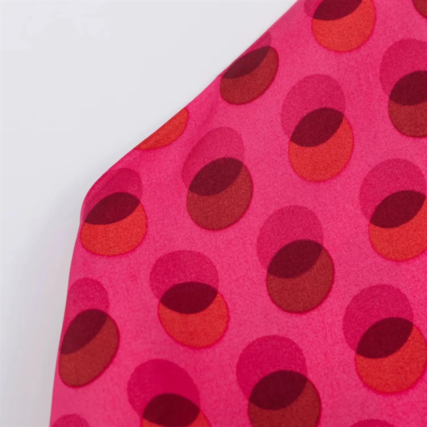 Pure fuchsia satin fabric drape macro, two-tone overlapping circle dot print, soft glossy silky luster, lightweight woven texture