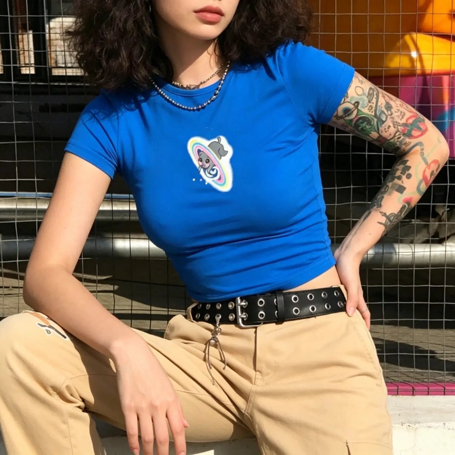 Full front outdoor model shot vibrant blue fitted cropped t-shirt with cute cat planet graphic