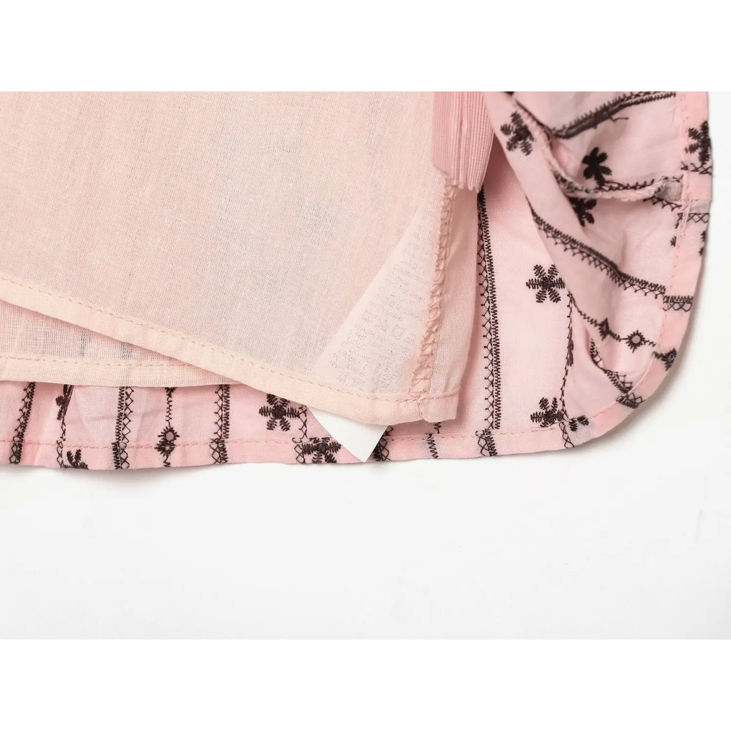 Inner view of lightweight solid pink lining with clean finished bottom hem