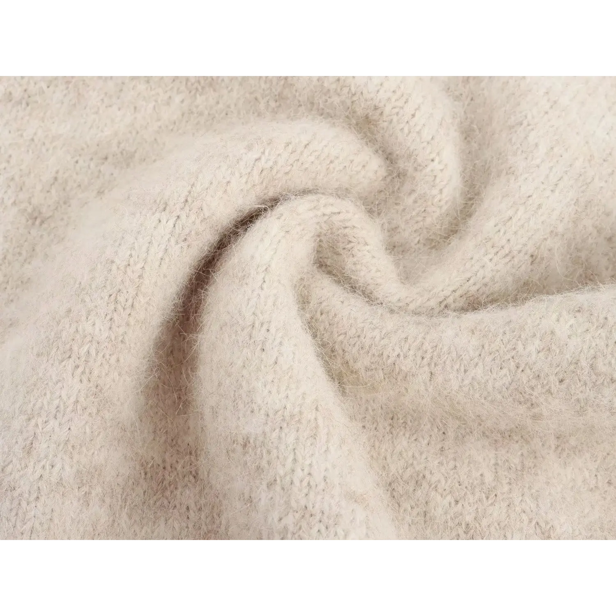 Macro close-up of soft fuzzy cream knit fabric texture of argyle sweater vest