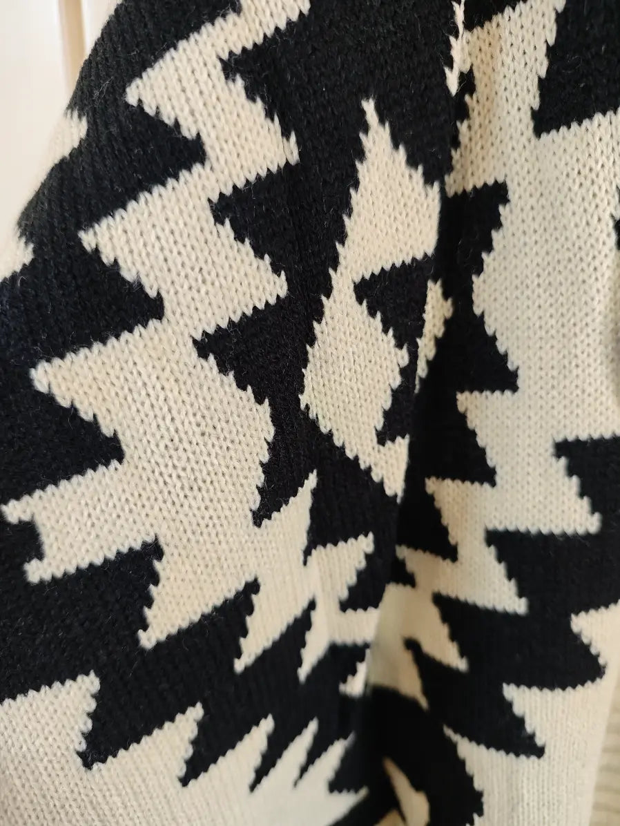 Macro close-up of black and cream geometric diamond intarsia knit