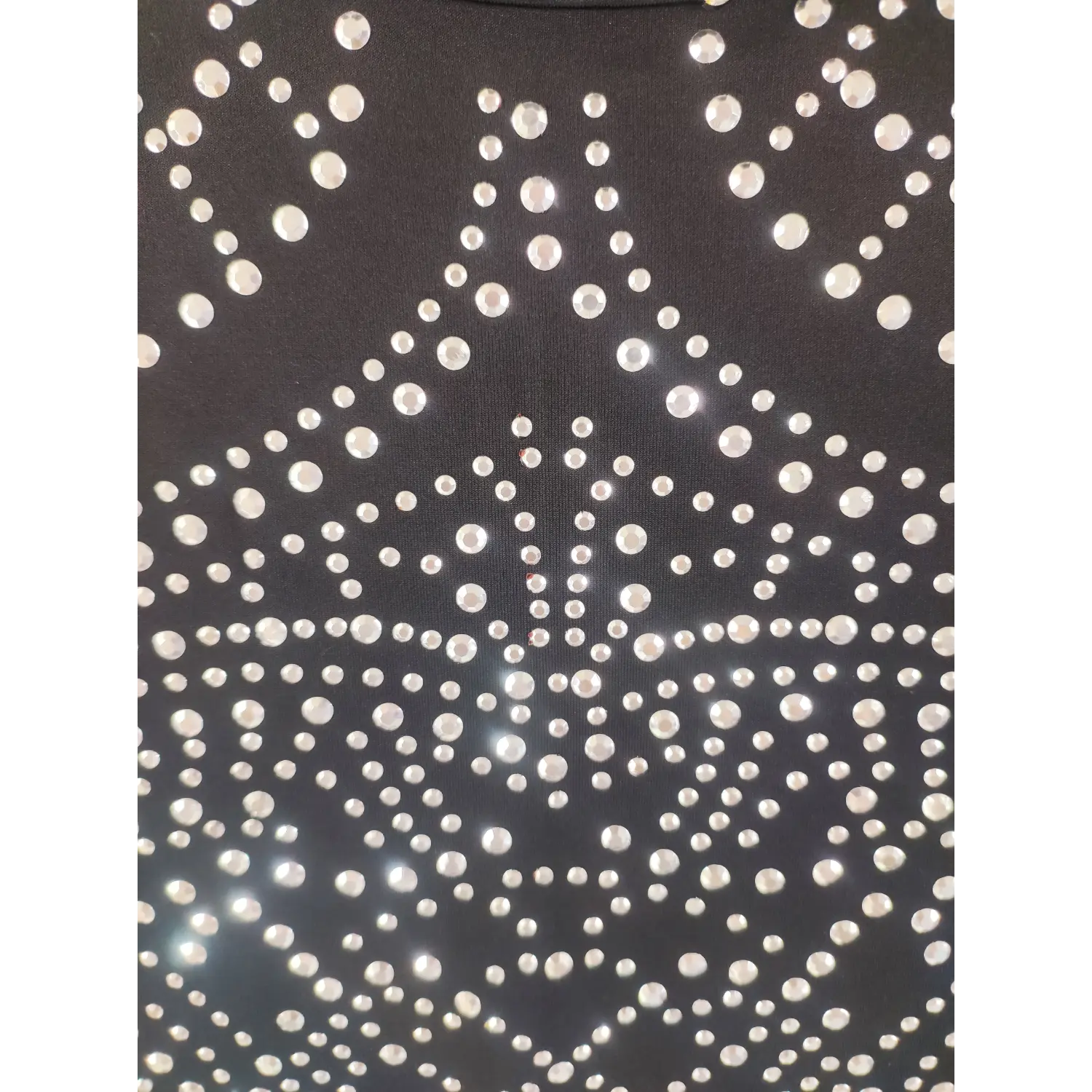 Close-up front bodice, intricate geometric silver rhinestone pattern on black dress fabric