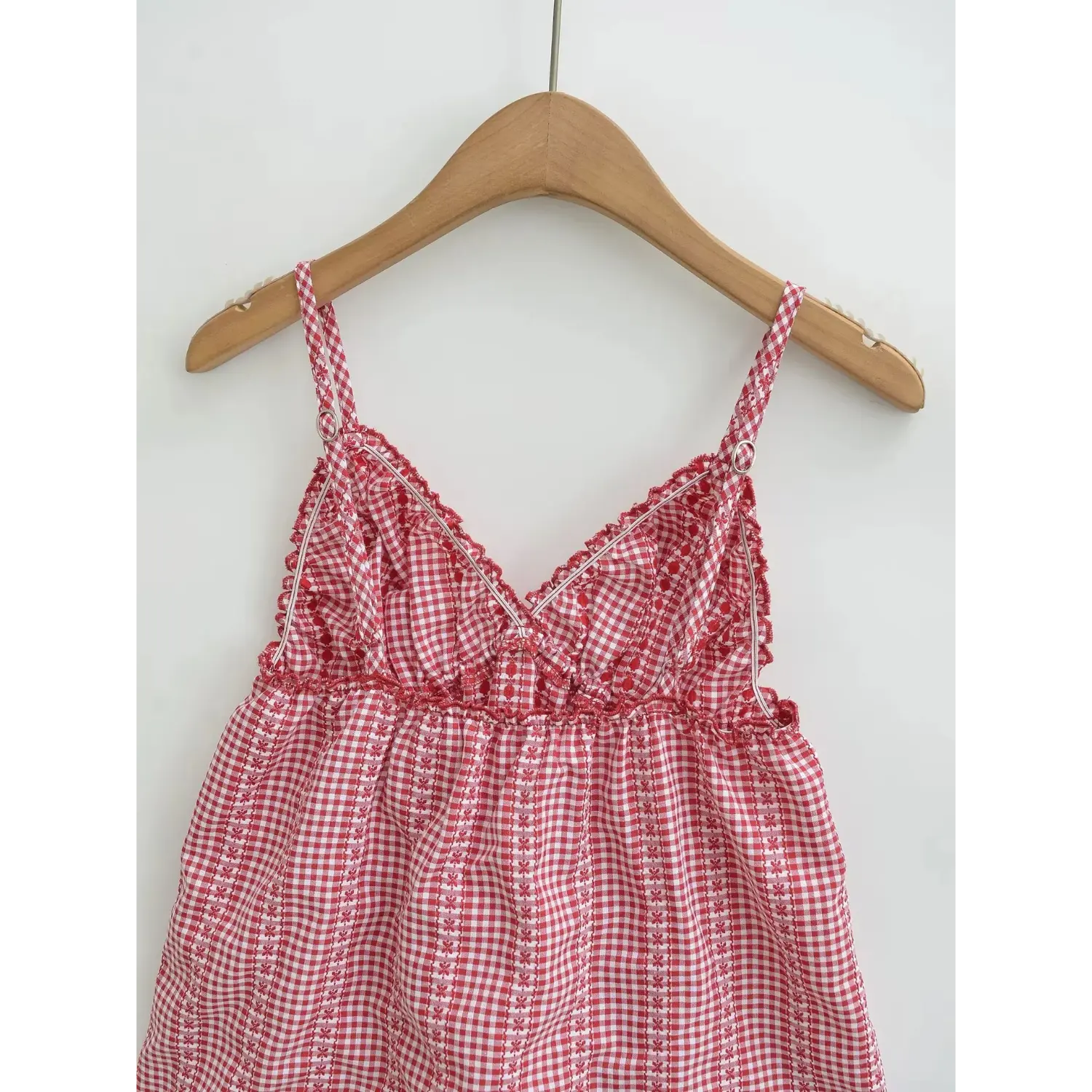 Adjustable thin printed strap red gingham cami top flat close-up, matching fabric buckle straps scalloped v-neck edge chiffon fabric white background shot
